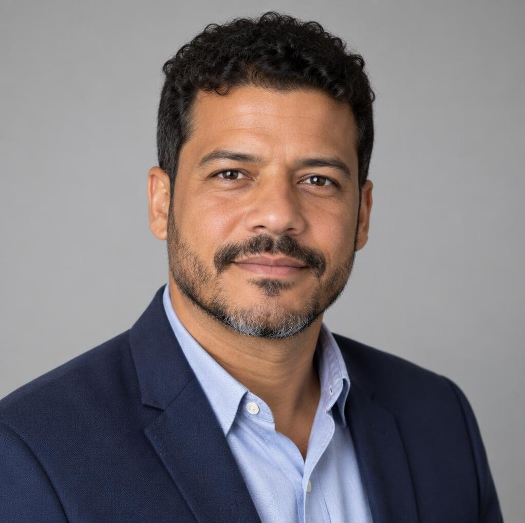 Professional headshot of a man with a calm expression