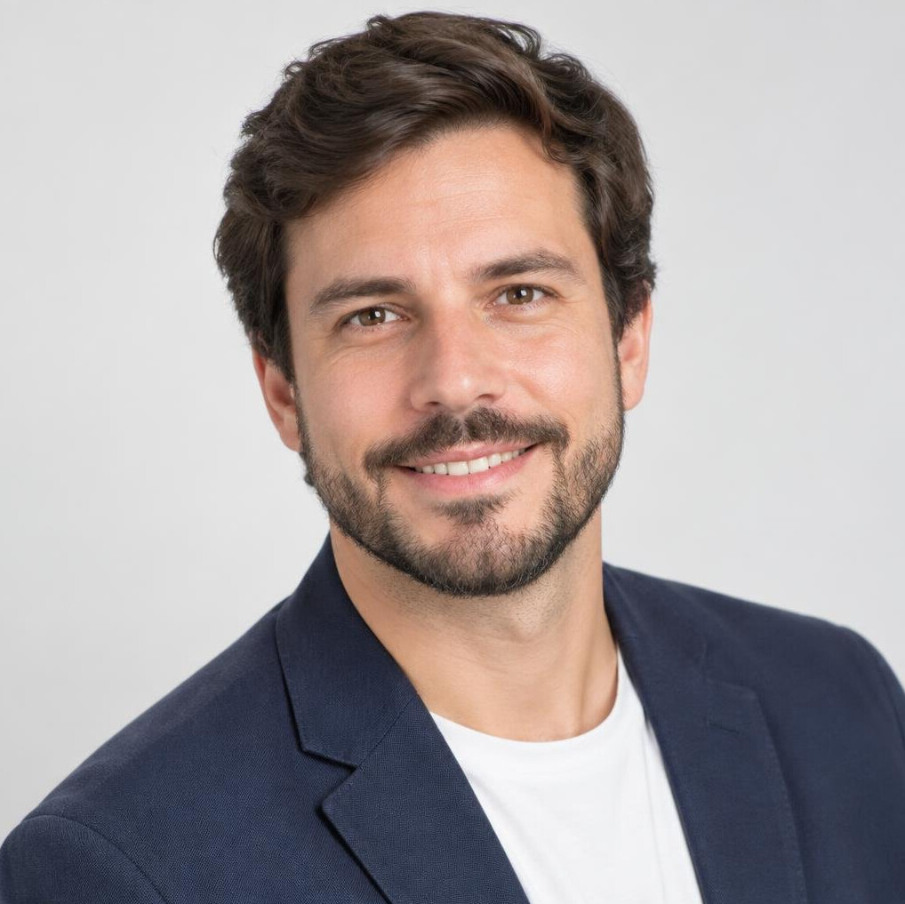Professional headshot of a man in a blazer