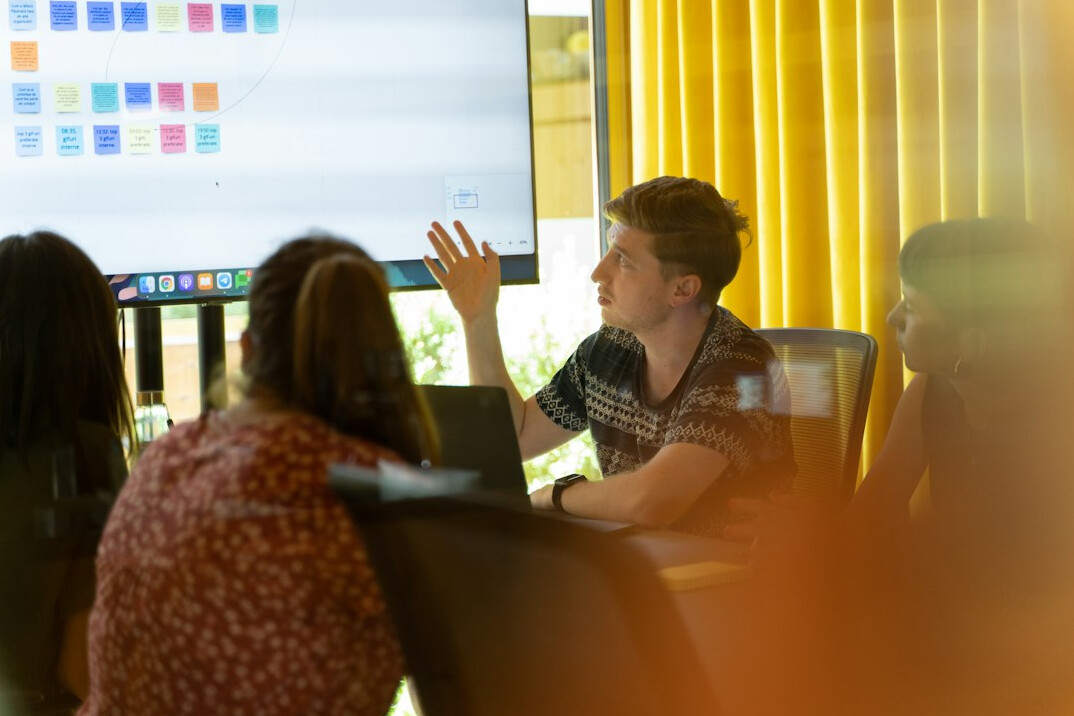 woman presenting to team